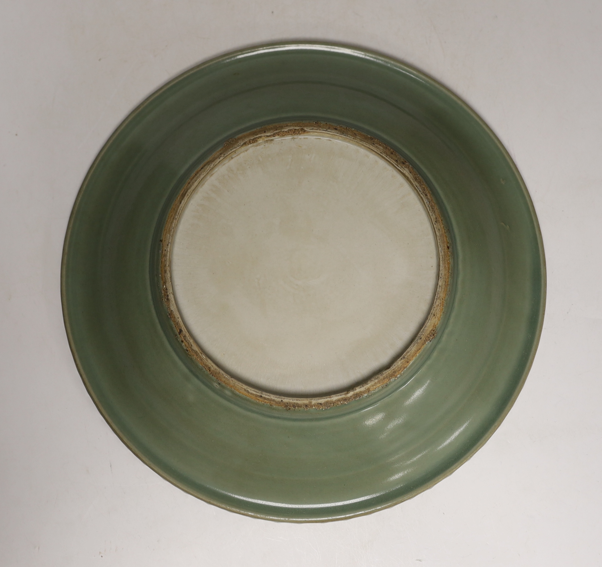 A large Chinese celadon glazed plate, 30cm